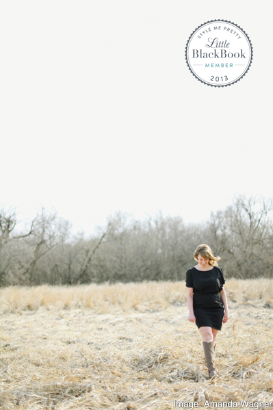 Photo of Anne-Marie Bouchard in a field with a Little Black Book Emblem. Image by Amanda Wagner.